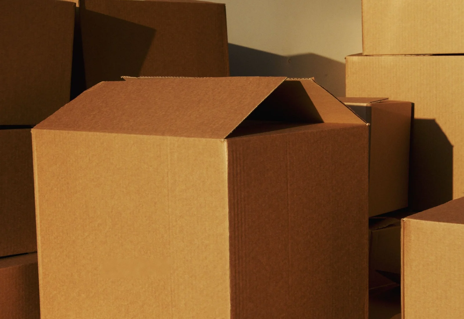 Unbranded corrugated cardboard boxes used to review paper packaging components