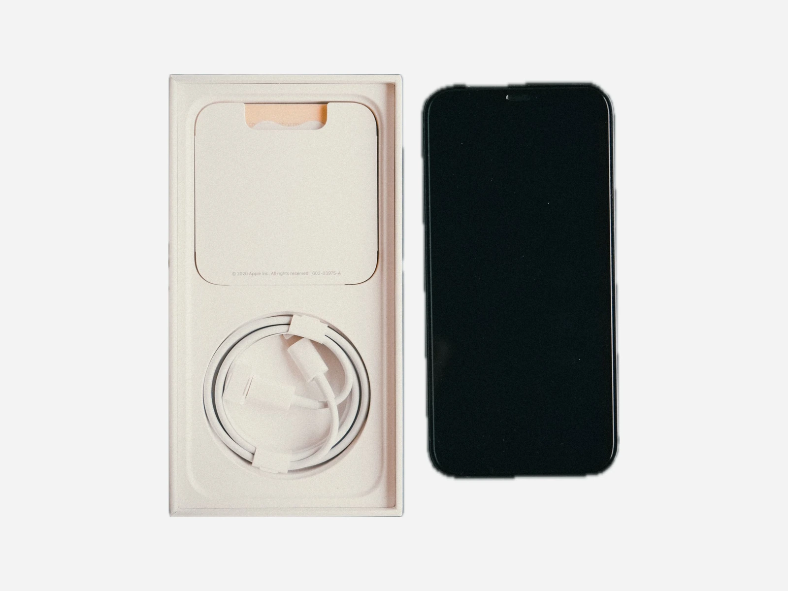 Device packaging with a cable compartment and paper insert
